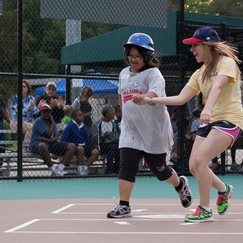 Player and buddy crossing home plate